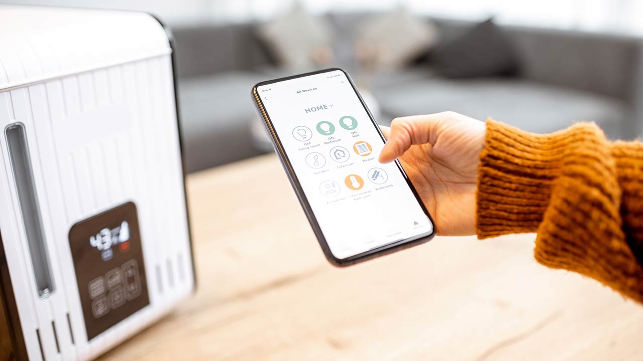 Close-up on a smart phone with launched home assistant application, controlling air humidifier at home