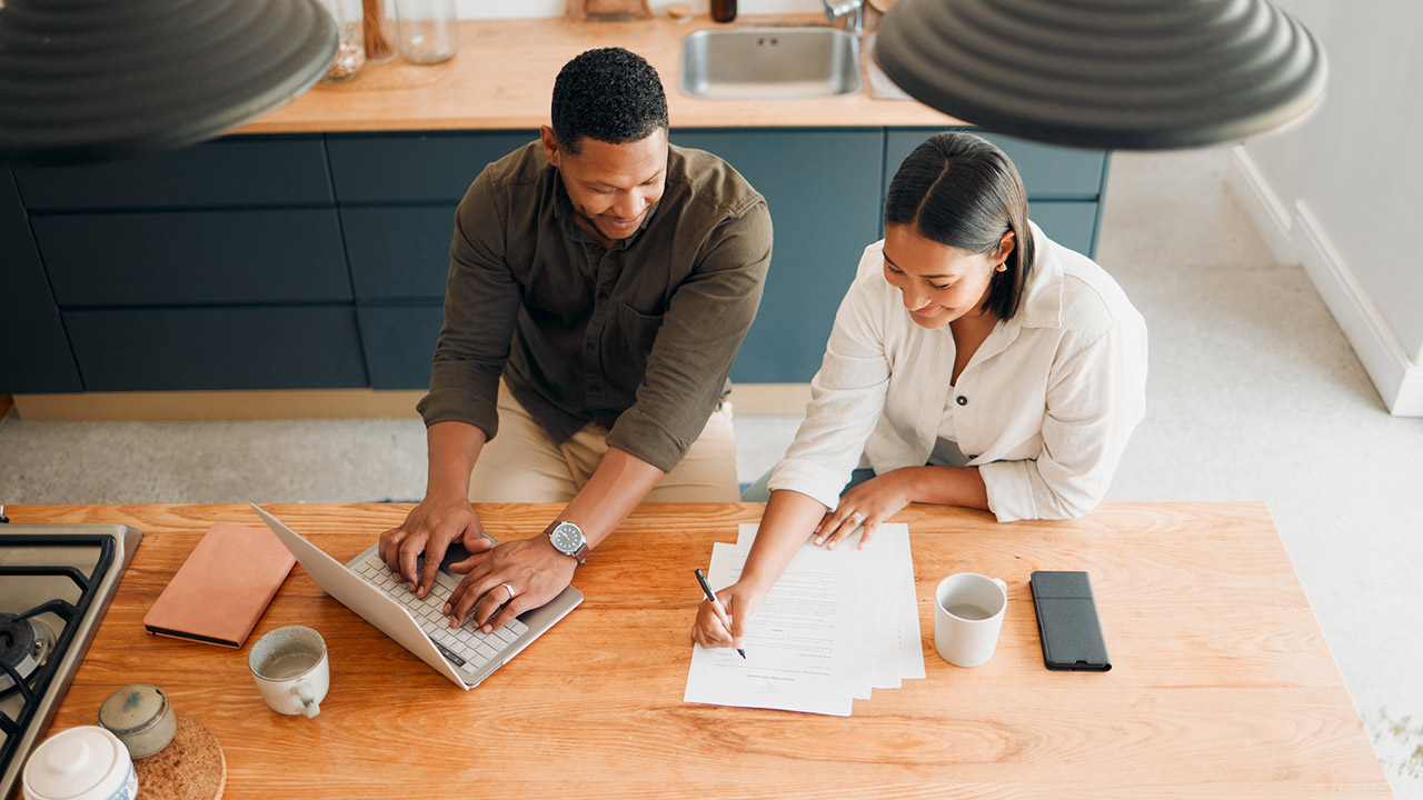 Couple calculating budget, finance and tax while planning investment, loan and bills at home from above