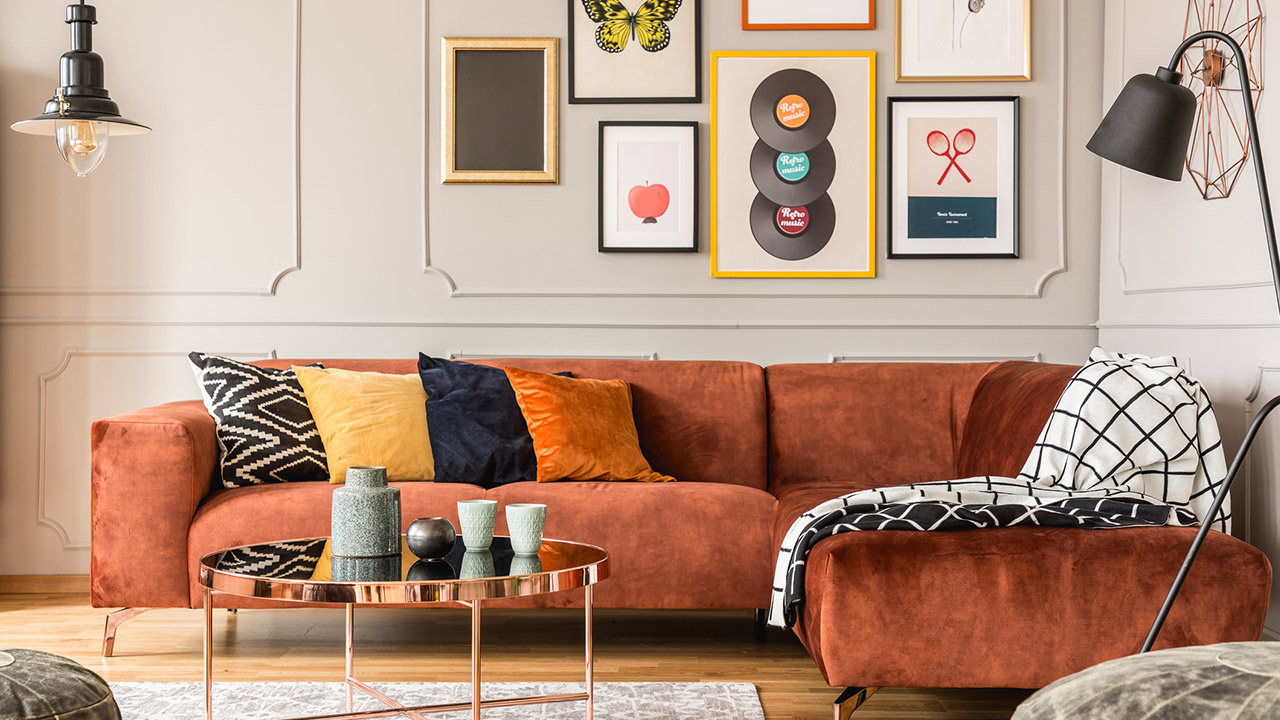 Eclectic living room interior with comfortable velvet corner sofa with pillows stock photo